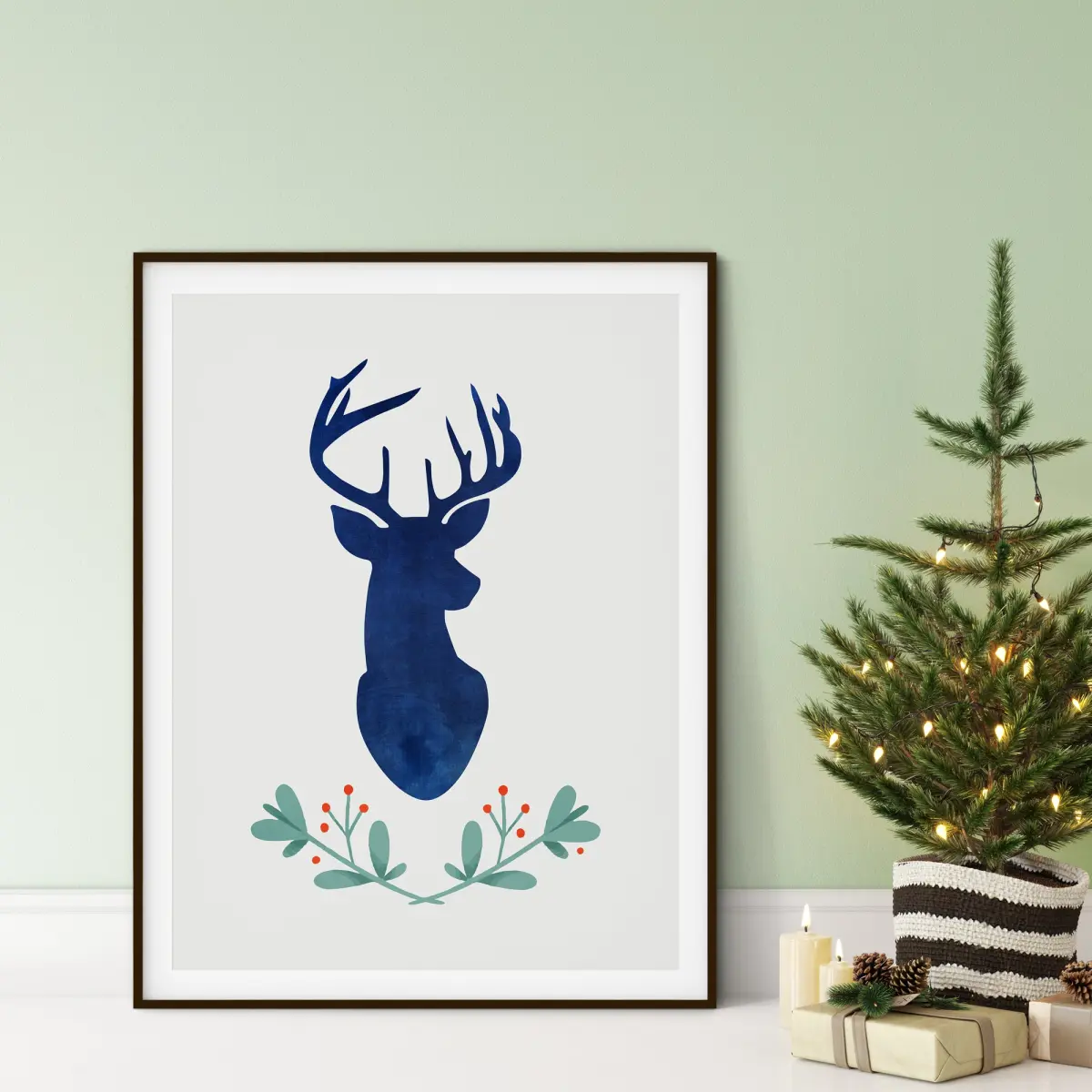 Navy watercolour stag silhouette above a botanical wreath of leaves and red berries